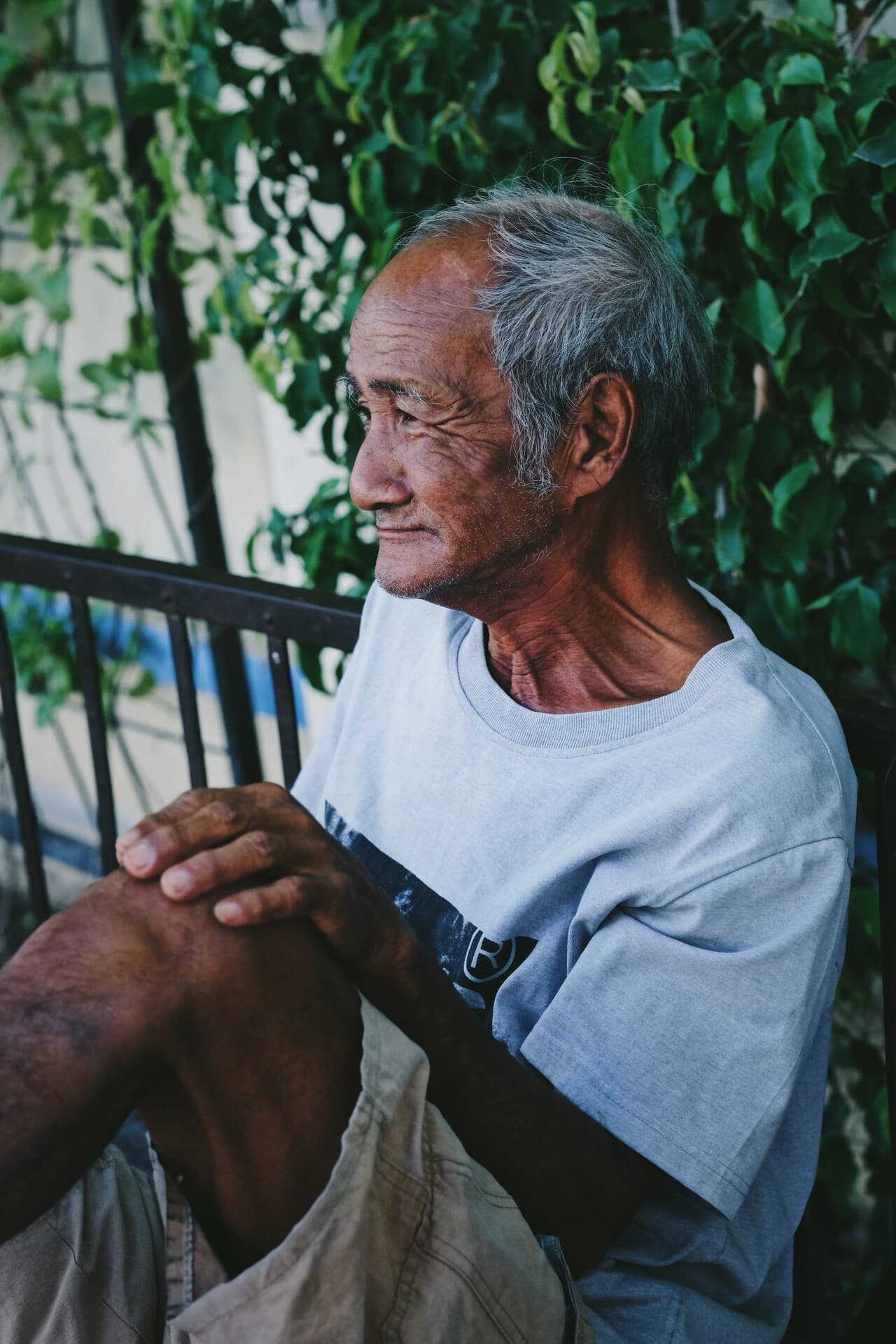 Old people waiting for work on the roadside